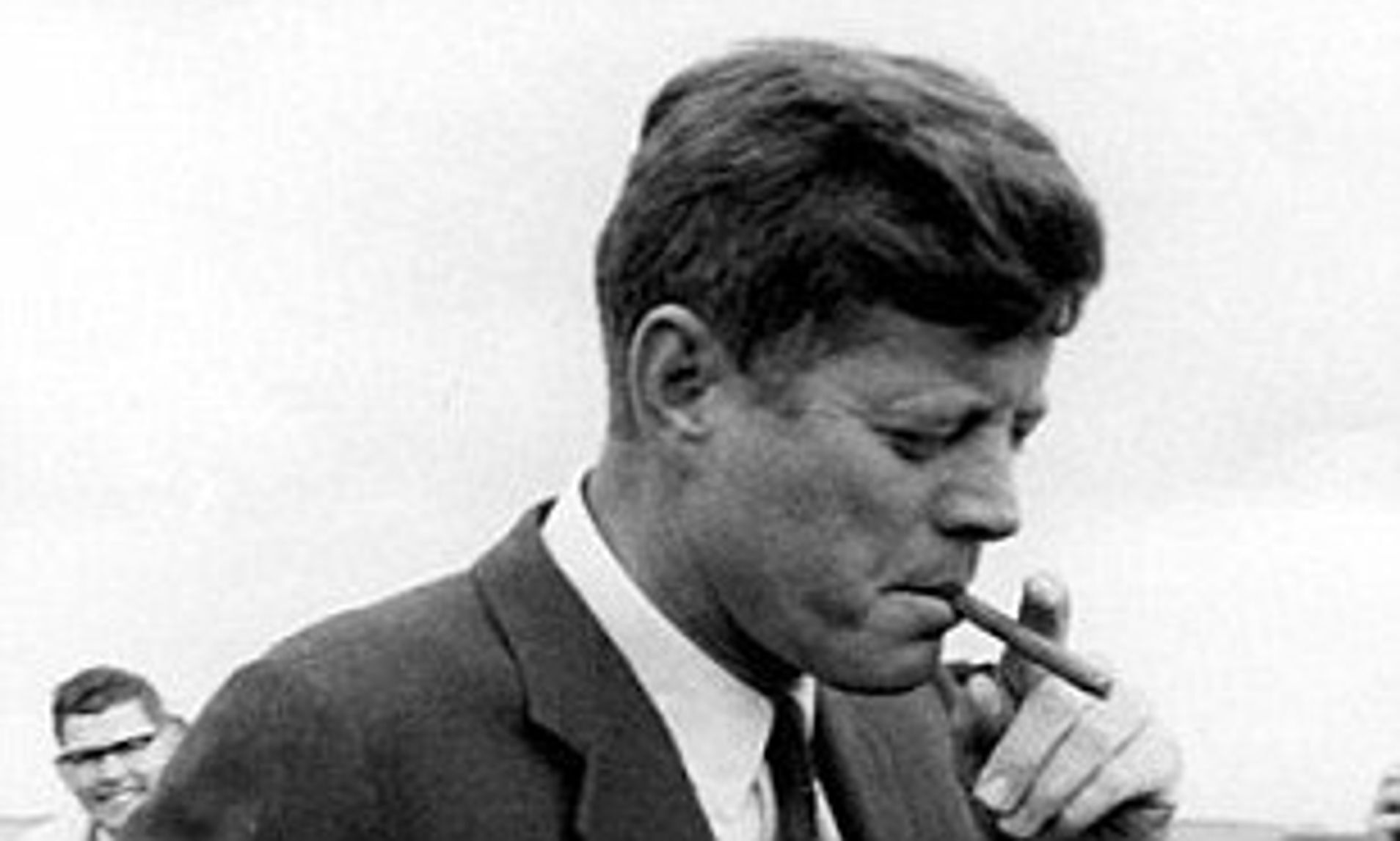 JFK smoking a Cuban cigar prior to the Cuban embargo