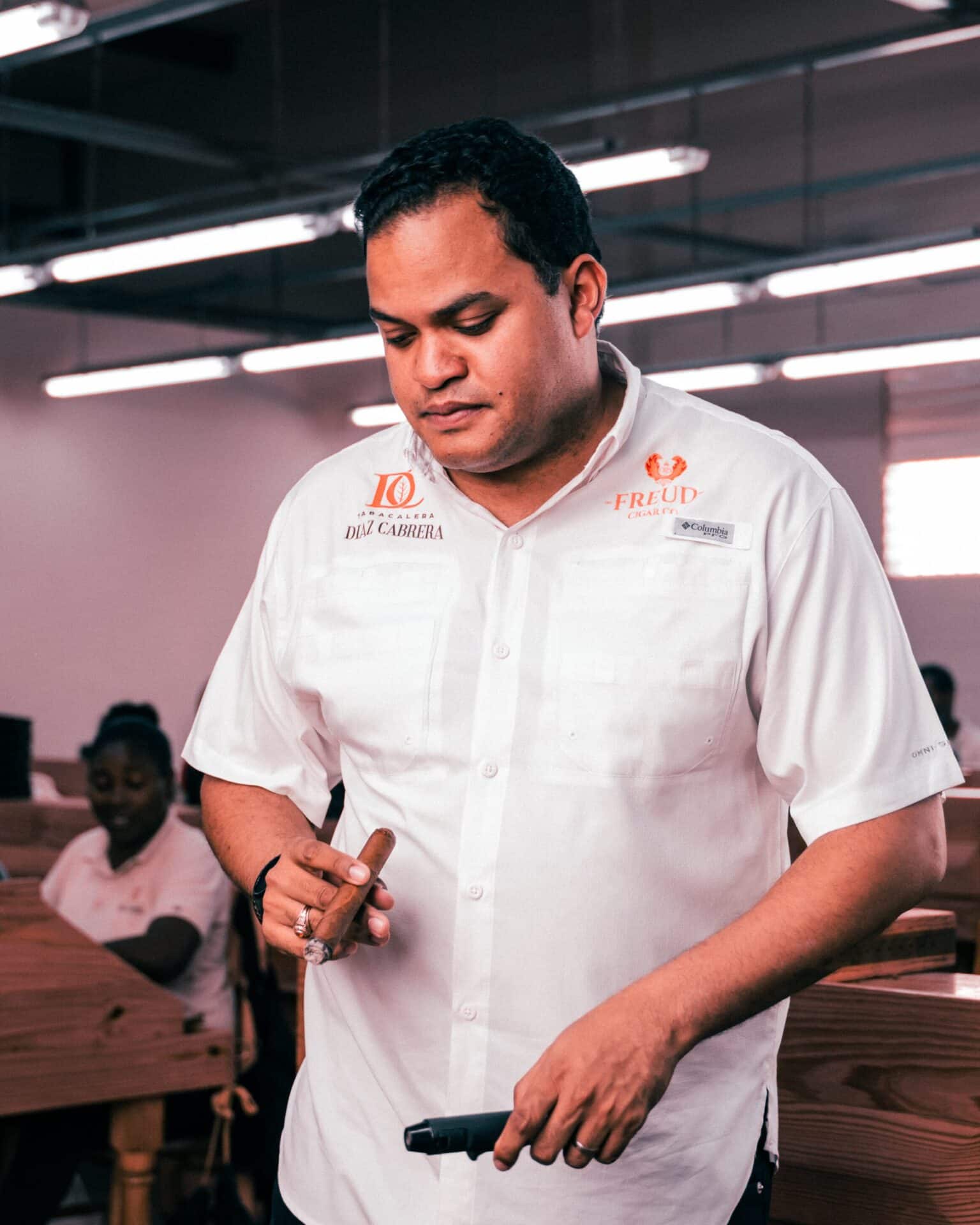 Emmanuel "Manny" Diaz overlooks a cigar rolling table at Tabacalera Diaz Cabrera in Santiago, Dominican Republic.